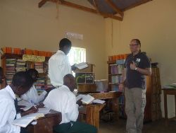 The Rev Alan McCann hands over a Study Bible for the Library at Bethel Royal High School in Nakasangola, the newest secondary school in the Fields of Life family.  The school was built in January/February 2010 by Hope Builders, from Kilkeel.  
